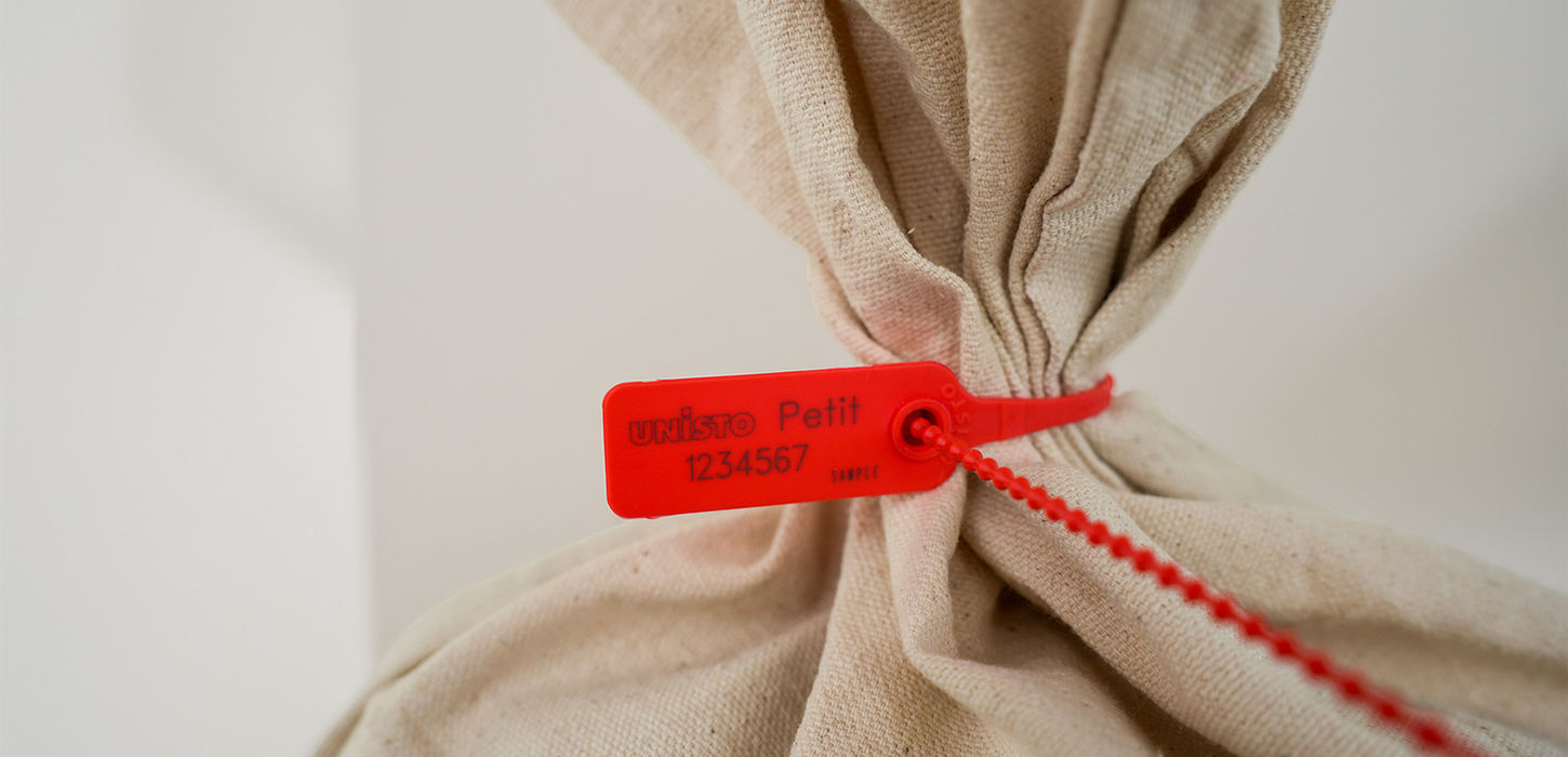 Unisto Petit one-piece security seal applied to a bag